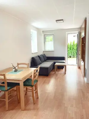 a living room with a table and a couch at Apartma Kati in Bovec