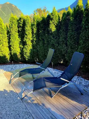a blue chair sitting on top of a wooden deck at Apartma Kati in Bovec