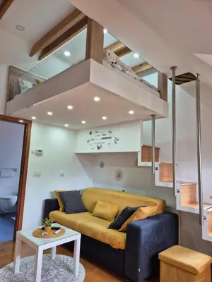 a living room with a couch and a loft at Juliana Apartment Bohinj Lake in Bohinj