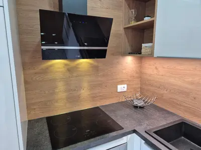 a kitchen with a counter top with a tv on the wall at Juliana Apartment Bohinj Lake in Bohinj