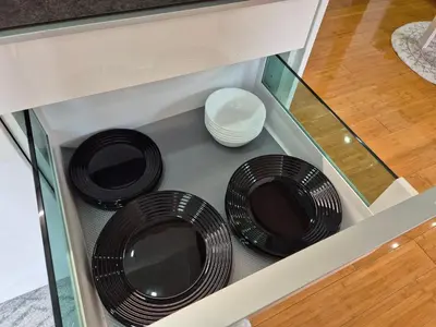 two black plates are sitting in a drawer at Juliana Apartment Bohinj Lake in Bohinj