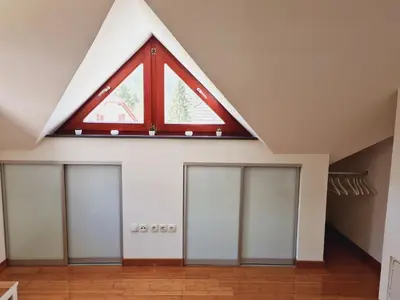 a window in the roof of a room with four doors at Juliana Apartment Bohinj Lake in Bohinj