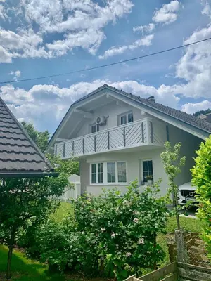 a white house with a gambrel roof at Appartment Pri Nacu in Bled