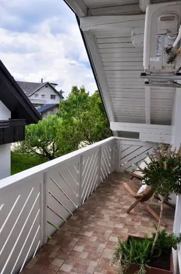 a porch with a white picket fence and a white picket at Appartment Pri Nacu in Bled
