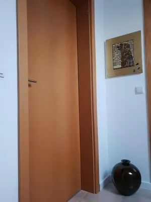 a wooden door in a room with a vase at Appartment Pri Nacu in Bled