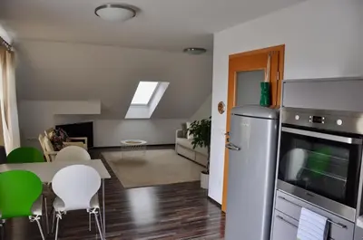 a kitchen and living room with a table and chairs at Appartment Pri Nacu in Bled