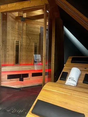 a room with two beds and a glass wall at Hiša Križaj in Bohinj