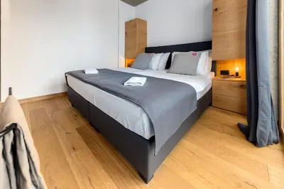 a bedroom with a large bed in a room at Hiša Križaj in Bohinj