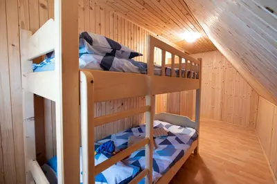 a bunk bed room with two bunk beds in a cabin at Mountain heart holiday house in Trenta