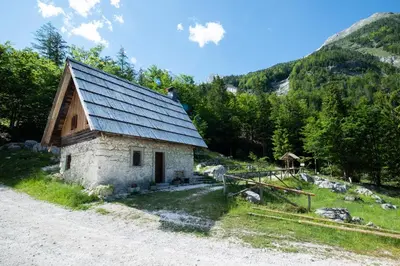 a small stone building with a slate roof on a mountain at Mountain heart holiday house in Trenta