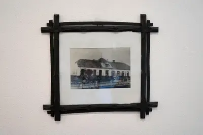 a framed picture of a house on a wall at Apartma Sveti Duh in Nova Vas