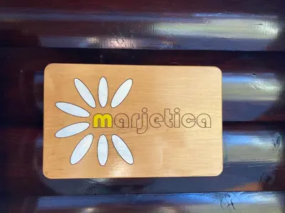 a wooden sign with the word antigua on it at Hiška Marjetica in Podčetrtek