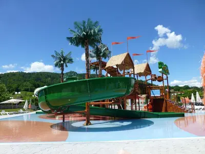 a water park with a green boat on a slide at Hiška Marjetica in Podčetrtek