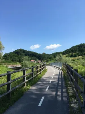 a road with a fence on the side at Hiška Marjetica in Podčetrtek