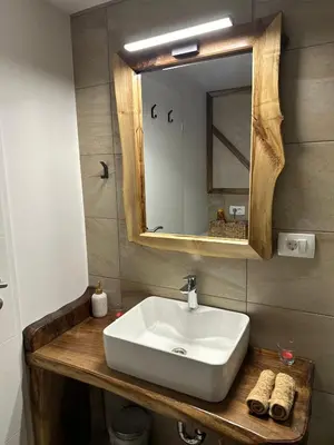a bathroom with a white sink and a mirror at Edenski vrt in Ivančna Gorica