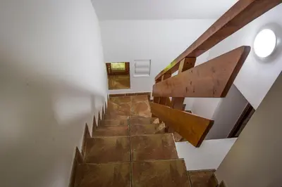 a staircase in a house with wooden treads at Natur pur Pikovo in Črna na Koroškem