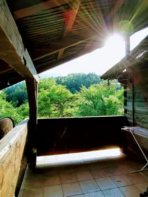 a view from the inside of a building with the sun shining at Natur pur Pikovo in Črna na Koroškem