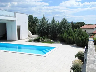 a swimming pool in the backyard of a house at Villa Lavanda in Kriz Sezana with private swimpool in Sežana