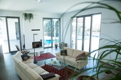 a living room with two couches and a tv at Villa Lavanda in Kriz Sezana with private swimpool in Sežana