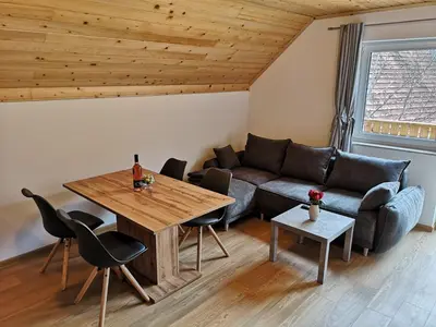 a living room with a couch and a table at Apartments Gaby in Gozd Martuljek