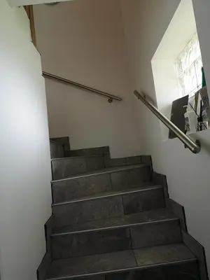 a staircase in a room with a stair railing at Apartments Gaby in Gozd Martuljek