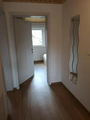 an empty room with a door and a window at Apartments Gaby in Gozd Martuljek