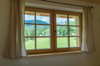 a window with a view of a mountain at Planinska koča na Uskovnici in Srednja Vas v Bohinju