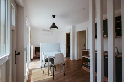 a kitchen and dining room with a white table and chairs at Apartment Oddih with terrace and private SAUNA in Bled