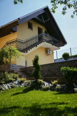 a house with a balcony on the side of it at Apartment Oddih with terrace and private SAUNA in Bled