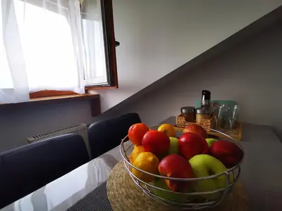 a bowl of fruit sitting on a table at Rose 8 Bled in Bled