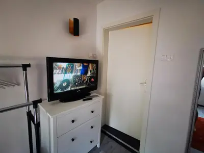 a television sitting on a dresser in a bedroom at Rose 8 Bled in Bled