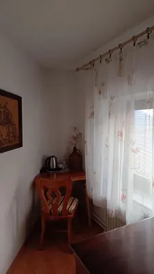 a room with a table and a chair and a window at Apartma in sobe Tanja in Podbrdo