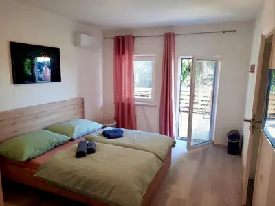 a bedroom with a bed with shoes on it at Rooms Optim in Ptuj