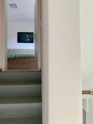a door leading to a bedroom with a mirror at Rooms Optim in Ptuj