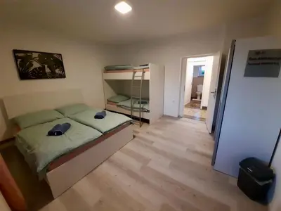 a small bedroom with a bed and a closet at Rooms Optim in Ptuj