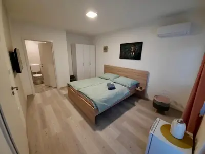 a bedroom with a bed in a room at Rooms Optim in Ptuj
