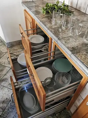 a cabinet filled with plates and dishes in a kitchen at Charming village house with patio and garden in Slovenske Konjice