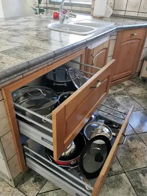 an open drawer in a kitchen with pots and pans at Charming village house with patio and garden in Slovenske Konjice