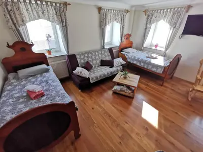 a living room with a couch and a table at Charming village house with patio and garden in Slovenske Konjice