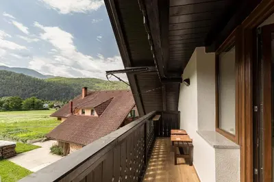 a balcony with a view of a house at Apartmaji Rupnik in Bohinjska Bistrica