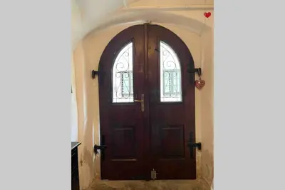 a wooden door with two windows in a hallway at OLD TOWN 14 in Ljubljana
