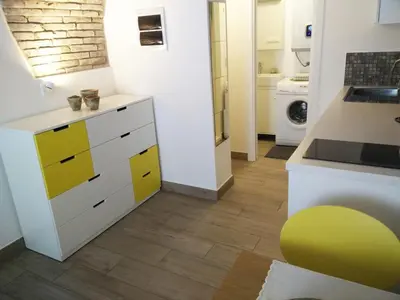 a kitchen with yellow and white cabinets in a room at OLD TOWN 14 in Ljubljana