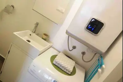 a bathroom with a sink and a toilet with a tablet on it at OLD TOWN 14 in Ljubljana