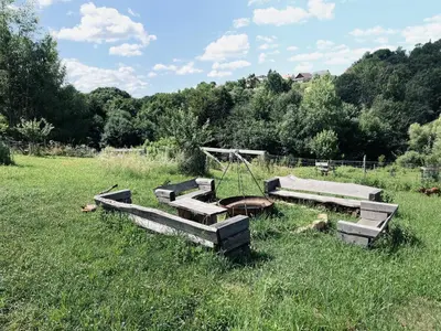 a group of benches in a field of grass at Boutique Glamping Divja DiVine in Zgornja Korena
