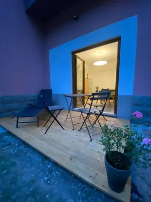 a room with a table and chairs and a blue wall at Apartment Nona Polda in Kobarid