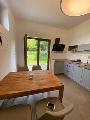 a kitchen and dining room with a wooden table and chairs at Apartment Nona Polda in Kobarid
