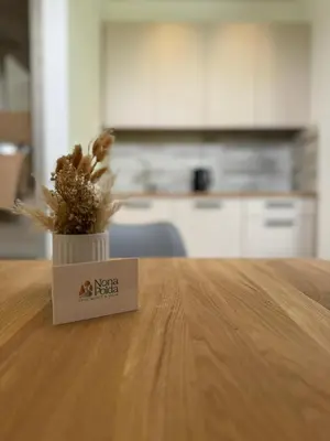 a vase with a plant sitting on top of a table at Apartment Nona Polda in Kobarid
