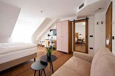 a bedroom with a bed and a couch and a table at Hiša Ančka, Šenčur - 3 min to the Airport in Kranj