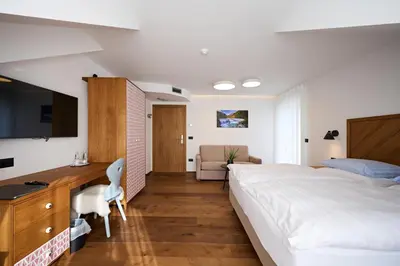 a bedroom with a large bed and a desk and a computer at Hiša Ančka, Šenčur - 3 min to the Airport in Kranj