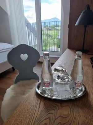 a table with two bottles and a plate on it at Hiša Ančka, Šenčur - 3 min to the Airport in Kranj